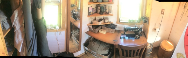Pink room/bathroom panorama. Left to right: clothing storage, bolts of merino wool fabric, sewing machine and storage, bathroom and composting toilet